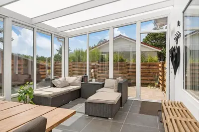 a screened in porch with a couch and chairs at 780-Thisted-Molgaardsvej-60 in Thisted