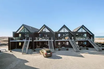 a house on the beach with a car parked in front at 526-Thisted-Havstokken-20-A in Thisted