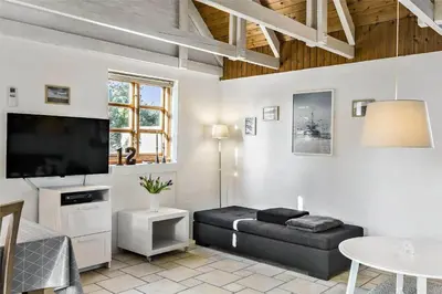 a living room with a couch and a flat screen tv at 707-Thisted-Lyngvej-12 in Thisted