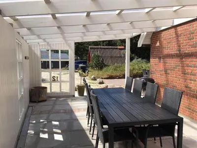 a wooden table and chairs on a patio at 707-Thisted-Lyngvej-12 in Thisted