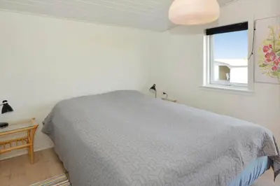 a white bedroom with a bed and a window at 1303-Thisted-Fiskervej-47 in Thisted