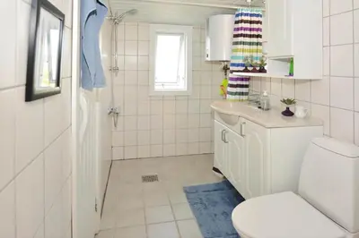 a white bathroom with a toilet and a sink at 1303-Thisted-Fiskervej-47 in Thisted