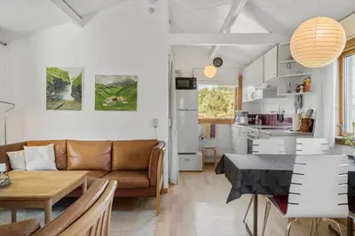 a living room and kitchen with a couch and a table at 168-Thisted-Sandtornvej-8 in Thisted