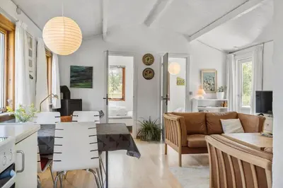 a kitchen and living room with a table and a couch at 168-Thisted-Sandtornvej-8 in Thisted