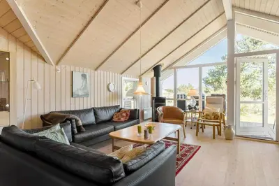 a living room with a couch and a table at 876-Thisted-Klemsvej-27 in Thisted