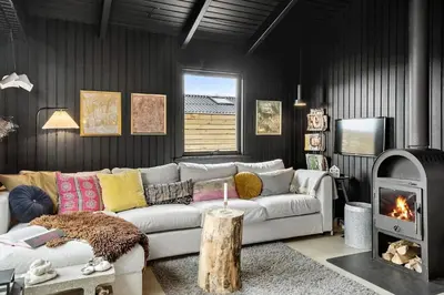 a living room with a white couch and a fireplace at 1014-Thisted-Sletningen-7 in Torsted