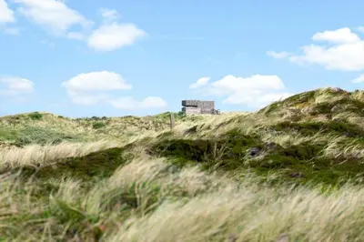 a building on top of a hill with grass at 334-Snedsted-Somaerkevej-64-B in Snedsted