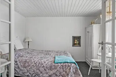 a bedroom with a bed with a blue pillow on it at 846-Thisted-Vesterhavsgade-6-A in Thisted