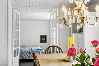 a dining room with a table and a bedroom at 846-Thisted-Vesterhavsgade-6-A in Thisted
