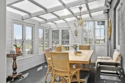a dining room with a table and chairs and windows at 846-Thisted-Vesterhavsgade-6-A in Thisted