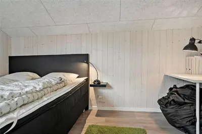 a bedroom with a bed with a black headboard at 897-Thisted-Nordsovej-46-C in Thisted