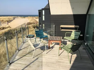 a deck with chairs and a table and a bench at 794-Thisted-Havstokken-26-1 in Thisted