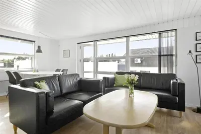 a living room with a black couch and a table at 736-Thisted-Kuttervej-6 in Thisted