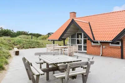 a picnic table and benches in front of a building at 150-Thisted-Orredvej-32 in Thisted