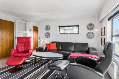 a living room with a black couch and red chairs at 310-Thisted-Store-Knuds-Vej-7 in Thisted