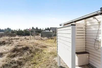 a white shed with a bench next to a field at 310-Thisted-Store-Knuds-Vej-7 in Thisted