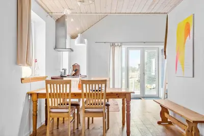 a dining room with a wooden table and chairs at 1017-Thisted-Hvidbakken-17 in Torsted