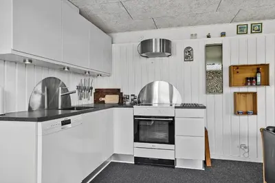 a kitchen with white cabinets and a stove top oven at 518-Thisted-Klemsvej-18 in Thisted