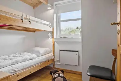 a bedroom with two bunk beds and a window at 273-Snedsted-Sarasvej-33 in Snedsted