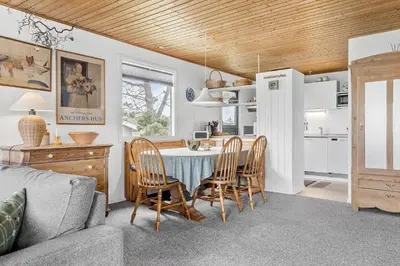 a kitchen and dining room with a table and chairs at 912-Thisted-Astien-17 in Torsted