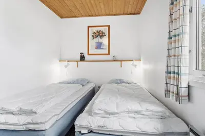 two twin beds in a room with a window at 912-Thisted-Astien-17 in Torsted