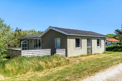 a small house on a grassy field next to a road at 149-Snedsted-Lykkens-Hab-39 in Snedsted
