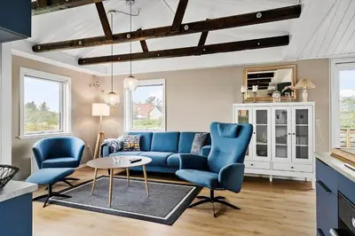 a living room with a blue couch and chairs at 149-Snedsted-Lykkens-Hab-39 in Snedsted