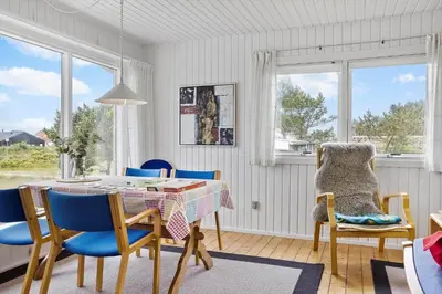 a dining room with a table and blue chairs at 131-Thisted-Aerenprisvej-13 in Thisted