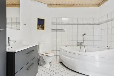 a white bathroom with a tub and a toilet and a sink at 487-Thisted-Hummervej-9 in Thisted