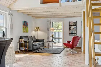 a living room with a couch and a red chair at 487-Thisted-Hummervej-9 in Thisted