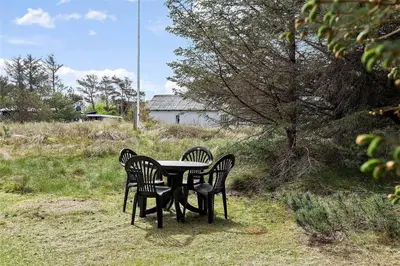 three chairs around a table in a field at 630-Thisted-Kristinesvej-40 in Thisted