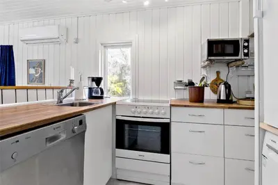 a white kitchen with a sink and a stove at 630-Thisted-Kristinesvej-40 in Thisted