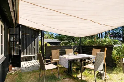 a patio with a table and chairs under a canopy at 255-Thisted-Kraen-Knudsens-Vej-13 in Thisted