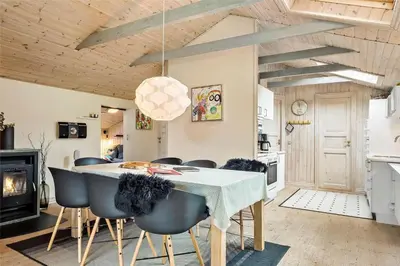 a kitchen and dining room with a table and chairs at 704-Thisted-Kristinesvej-54 in Thisted