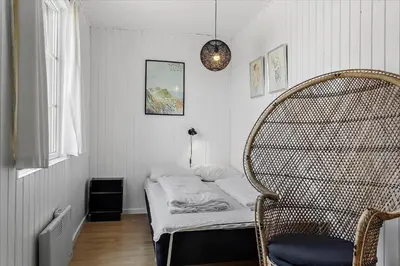 a small room with a bed and a chair at 406-Vestervig-Bekkasinvej-6 in Vestervig