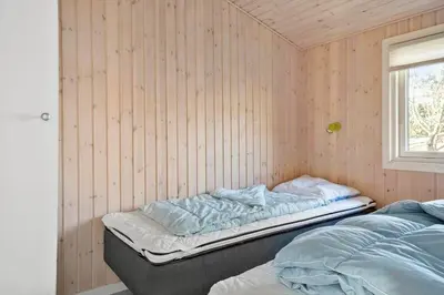 a room with two beds in it with a window at 475-Thisted-Muslingevej-5 in Thisted