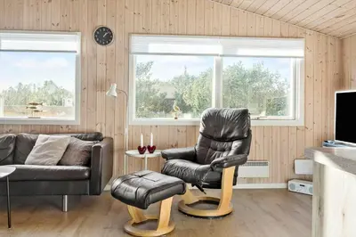 a living room with a leather chair and a couch at 475-Thisted-Muslingevej-5 in Thisted