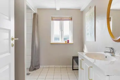 a white bathroom with a sink and a window at 492-Thisted-Tunvej-7-B in Thisted