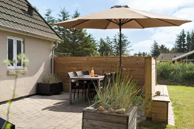 a patio with a table and an umbrella at 492-Thisted-Tunvej-7-B in Thisted