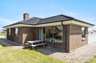 a brick house with a picnic bench in front of it at 138-Thisted-Lervej-8-B in Thisted