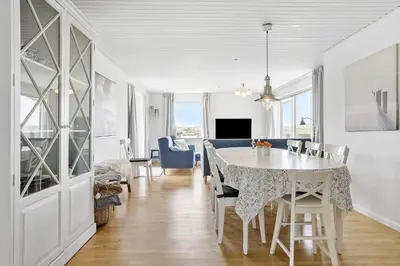 a dining room and living room with a table and chairs at 138-Thisted-Lervej-8-B in Thisted