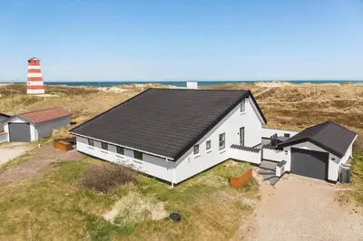 a white house with a lighthouse in a field at 652-Thisted-Orredvej-58 in Thisted