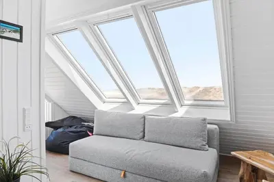 a living room with a couch and two windows at 652-Thisted-Orredvej-58 in Thisted