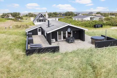 a house with a deck in the middle of a field at 525-Vestervig-Spovevej-5 in Vestervig