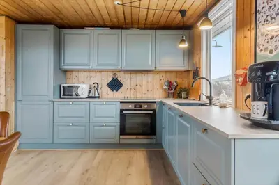 a kitchen with blue cabinets and a sink at 525-Vestervig-Spovevej-5 in Vestervig