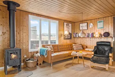 a living room with a couch and a stove at 525-Vestervig-Spovevej-5 in Vestervig