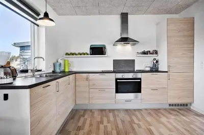 a kitchen with wooden cabinets and a stove top oven at 803-Thisted-Hummervej-3 in Thisted