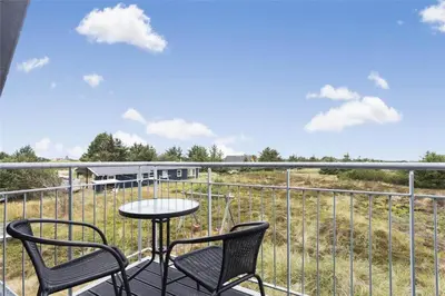a patio with two chairs and a table on a balcony at 803-Thisted-Hummervej-3 in Thisted