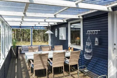 a patio with a table and chairs on a deck at 257-Thisted-Blamunkevej-34 in Thisted