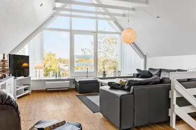 a living room with a couch and a large window at 541-Thisted-Nordsovej-49 in Thisted